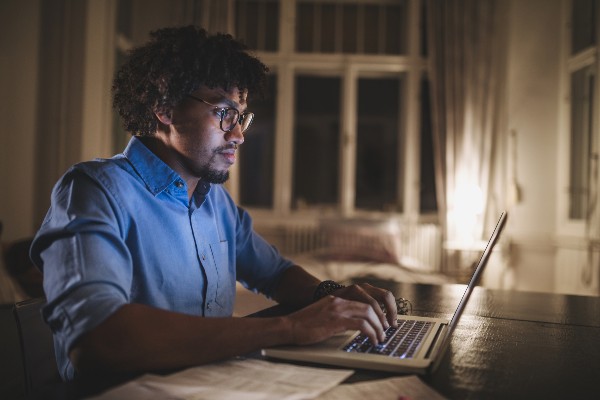 image depicting man using laptop